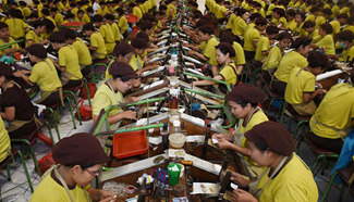 Indonesian workers package cigarettes in Malang