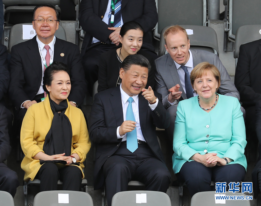 7月5日，国家主席习近平在柏林同德国总理默克尔共同观看中德青少年足球友谊赛。这是习近平和夫人彭丽媛同默克尔在看台上。 新华社记者 王晔摄